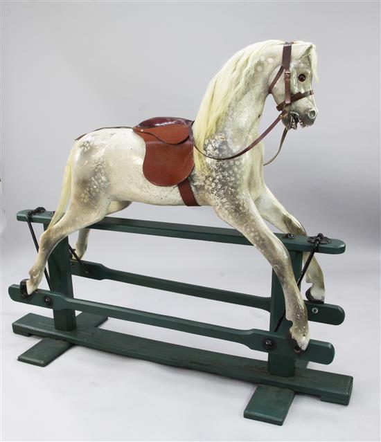 A large dapple grey rocking horse by Lines Brothers, overall 4ft 10ins, stands 4ft 4.5ins high